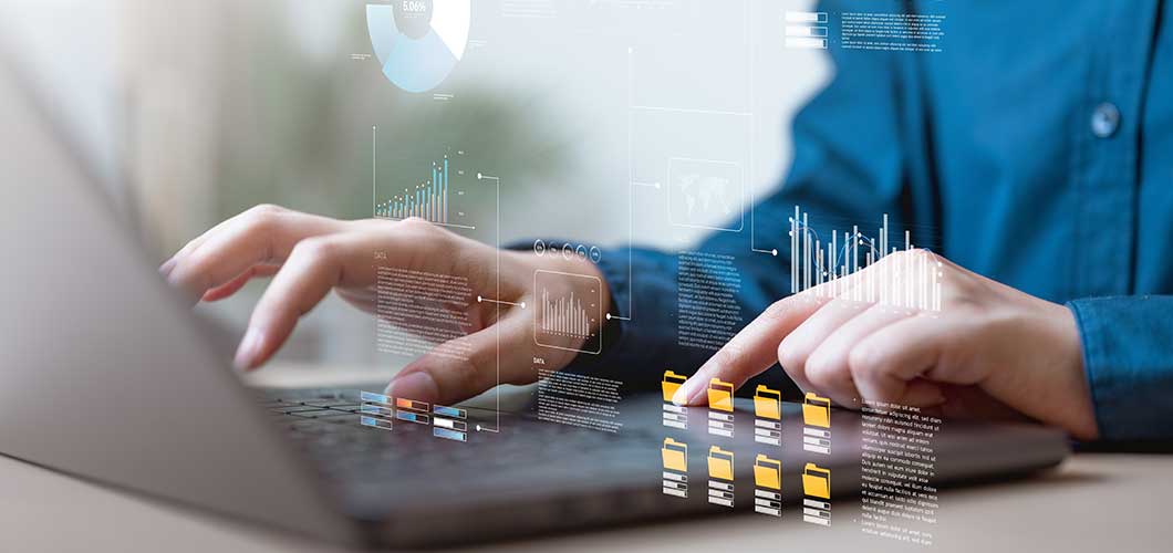 Hands typing on a laptop with digital data graphics and file icons overlaid on the screen